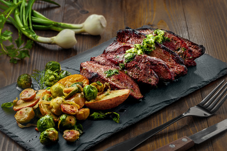 Tasty Pan-Seared Hanger Steak with brussels sprouts, potatoes and onion meal ona  table. Healthy home-made food.の写真素材
