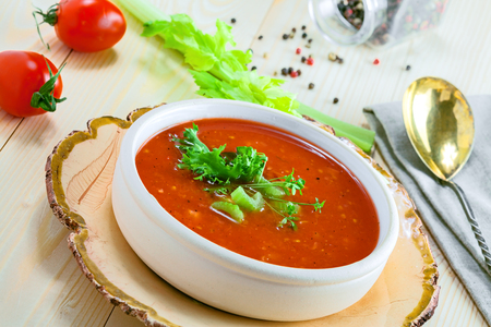 Delicious gazpacho and ingredients on a table. Vegetarian vegetable cold soup.の写真素材