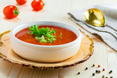 Delicious gazpacho and ingredients on a table. Vegetarian vegetable cold soup.の写真素材