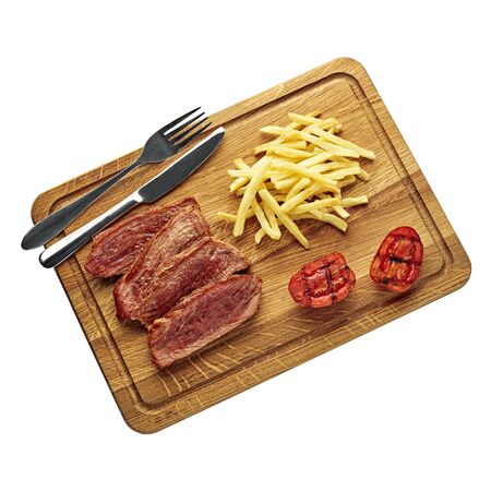 Steak with French fries and grilled cherry tomatoes on a cutting board. Classic meat meal isolated on white background. Top view, directly above flat lay shot.の写真素材