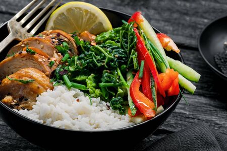 eriyaki chicken fillet, fresh cucumber, red bell pepper, stew cabbage and basmati rice Traditional Asian Buddha bowl meal.の写真素材