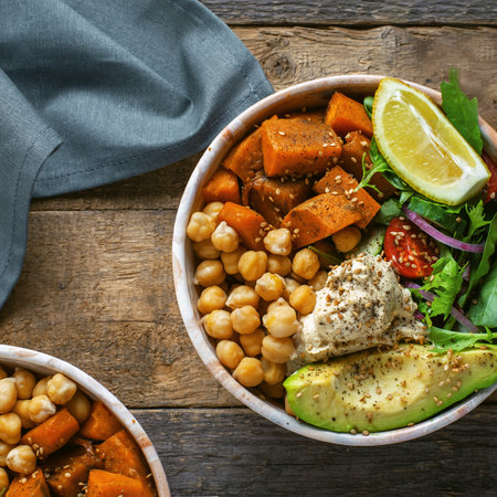 Bowl of chickpeas, salad, sweet potato, salad and avocadoの写真素材