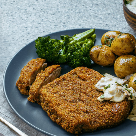 Traditional Schnitzel Dinner with Baby Potatoes. Close Up Shot.の写真素材