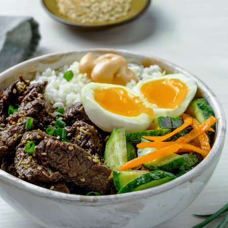 Healthy Protein-Rich Rice Bowl with Beef Strips and Soft Eggの写真素材