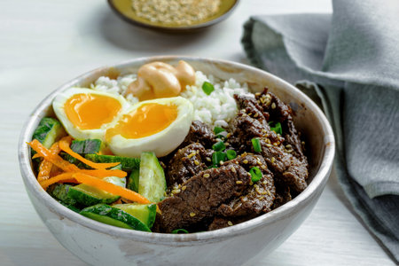 Asian Style Gourmet Lunch Bowl with Beef, Rice, and Fresh Vegetablesの写真素材