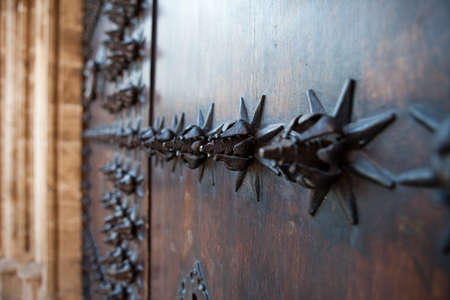 Wooden door with metal ornamentsの写真素材