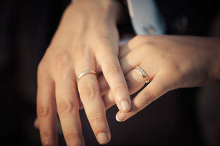 Hands of newly married couple showing their ringsの写真素材