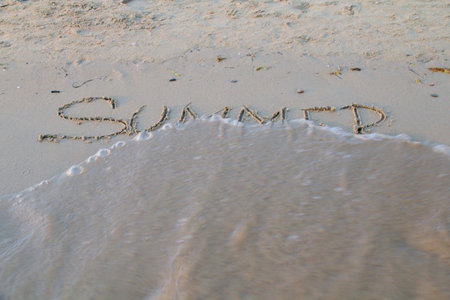 Photo shows a detail of the sign in the beach sand.の写真素材