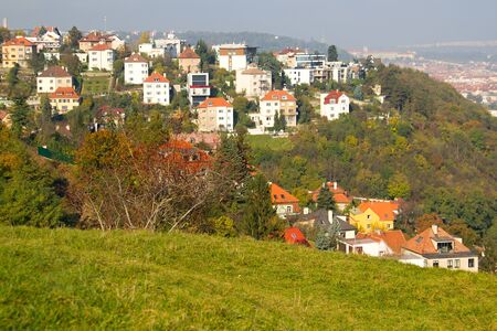 Photo shows a general city view with houses, trees and river.の写真素材