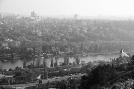 Photo shows a general city view with houses, trees and river.の写真素材