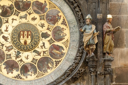 This photo shows a closeup of Prague old tower clock. There are various details like figurines, numbers, symbols and others.の写真素材