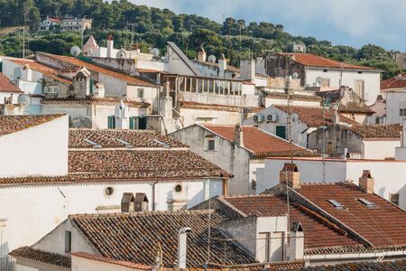 Photo shows close-up of general city view with various houses and roofs.の写真素材