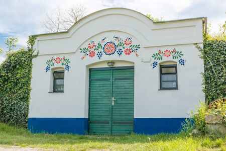 This photo shows detail of old colourful wine cellar entrance.の写真素材