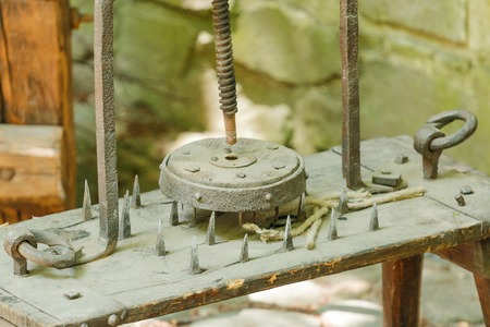 Photo shows close-up of historical wooden instrument of torture during a day.の写真素材