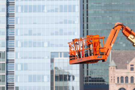 Photo shows close-up bottom view of glass skyscraper during a day.の写真素材