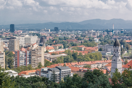 Photo shows general cityscape view with various houses in summer.の写真素材
