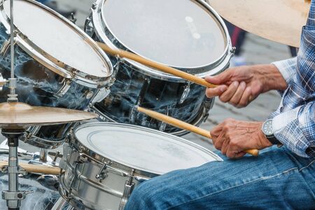 Photo shows close-up of of city drummer and his hands during a day.の写真素材