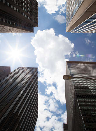 A cross in the Sky between skyscrapersの写真素材