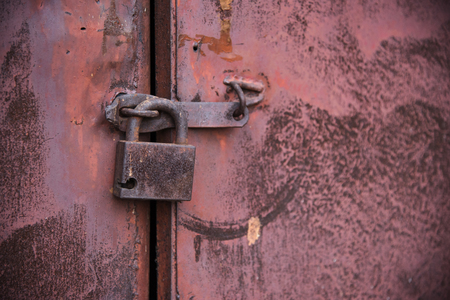 The old door locked with a padlock hanging brackets. Set of backgroundsの写真素材