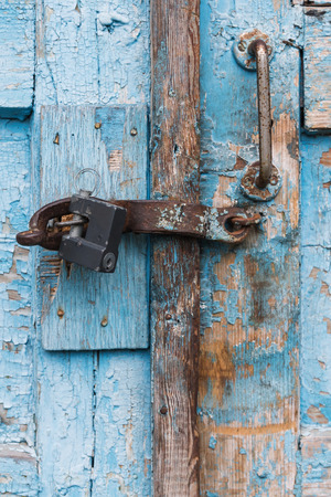 The old door locked with a padlock hanging brackets. Set of backgroundsの写真素材