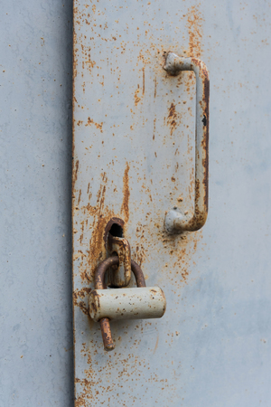 The old door locked with a padlock hanging brackets. Set of backgroundsの写真素材