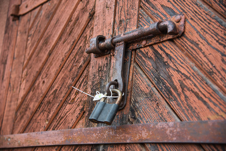 The old door locked with a padlock hanging brackets. Set of backgroundsの写真素材