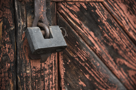 The old door locked with a padlock hanging brackets. Set of backgroundsの写真素材