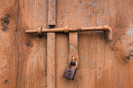 The old door locked with a padlock hanging brackets. Set of backgroundsの写真素材