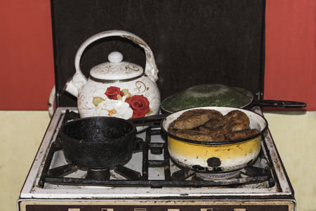 In the old gas stove is a pot of pies and other dishes, vintage effect. Ukraineの写真素材