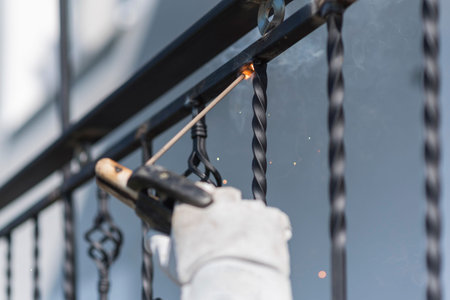 A worker welding metal handrails on the stairs. Ukraine.の写真素材