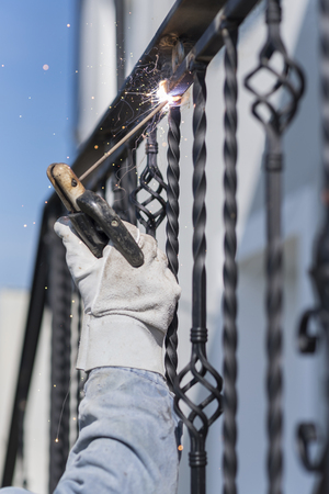 A worker welding metal handrails on the stairs. Ukraine.の写真素材