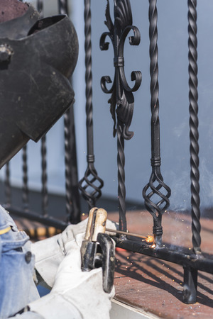 A worker welding metal handrails on the stairs. Ukraine.の写真素材