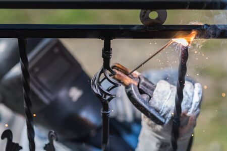 A worker welding metal handrails on the stairs. Ukraine.の写真素材