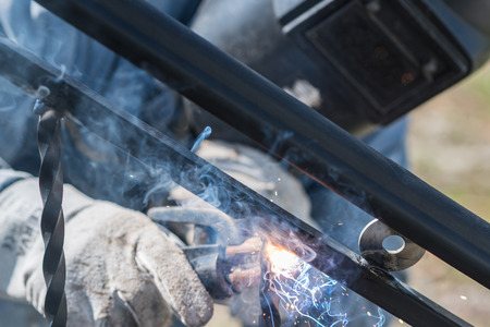 A worker welding metal handrails on the stairs. Ukraine.の写真素材