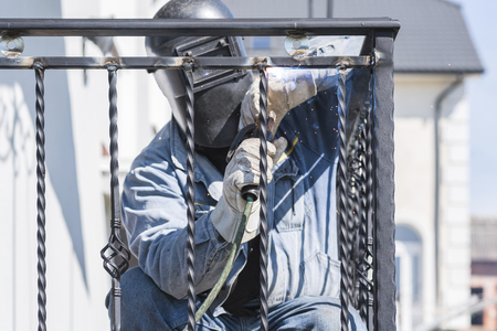 A worker welding metal handrails on the stairs. Ukraine.の写真素材