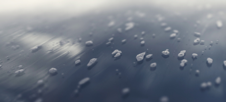 Detail of car window during washing, bubbles and reflection of the sky, backgroundの写真素材