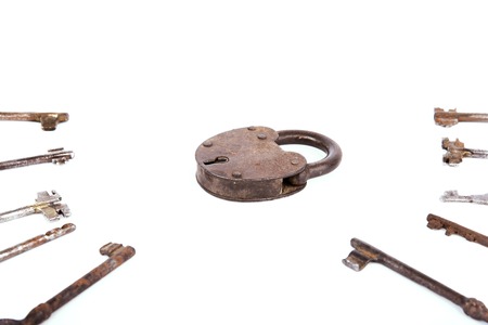 Ancient rusty padlock with collection of keys isolated on white background. Setの写真素材