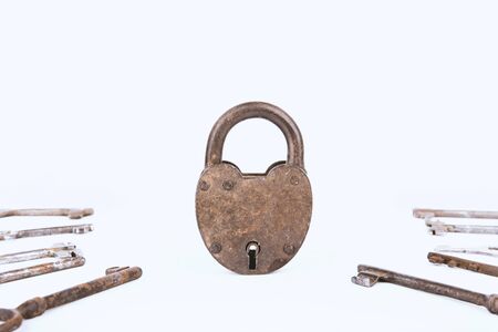 Ancient rusty padlock with collection of keys isolated on white background. Setの写真素材