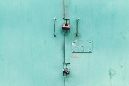 The old door locked with a padlock hanging brackets, set of backgroundsの写真素材