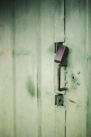 The old door locked with a padlock hanging brackets, set of backgroundsの写真素材