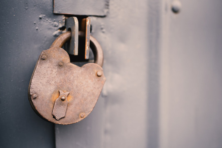 The old door locked with a padlock hanging brackets, set of backgroundsの写真素材