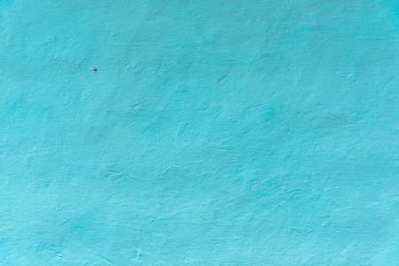 Wall whitewashed by lime, azure color, nail at wall, textured background. Ukraineの写真素材