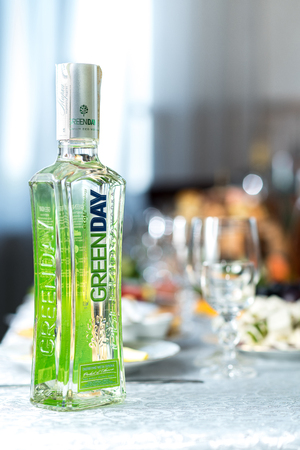 Drohobych, Ukraine - August 12, 2017: Green Day bottle on the festive table, wedding table in the restaurantのeditorial素材