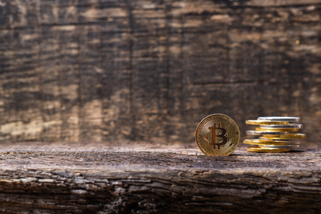 Many golden and silver bitcoins on a wooden surface, background with vintage effect, cryptocurrency concept for business idea, setの写真素材