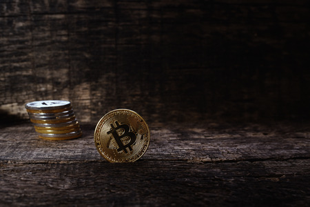 Many golden and silver bitcoins on a wooden surface, background with vintage effect, cryptocurrency concept for business idea, setの写真素材