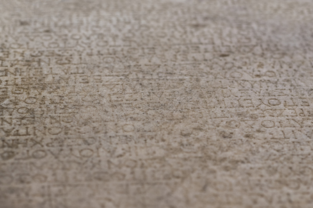 Ancient alphabets carved on a stone plateの写真素材