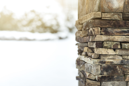 Design template for the greeting card on winter theme, column is constructed of stones on the foreground, snow environment on background, space for text, postcard, sunlightの写真素材