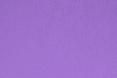 Detail of house facade in ultraviolet tones, plastered wall, fashion and style, textured background