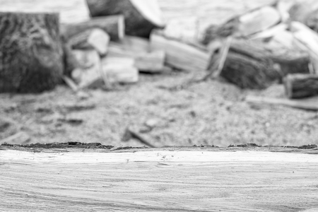 Oak firewood in front of blurry background with copy space, black and white effectの写真素材