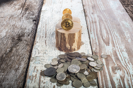 Bitcoin, litecoin ethereum and old coins, gold coins. Cryptocurrency concept: grow or fall. Retro wooden backgroundの写真素材